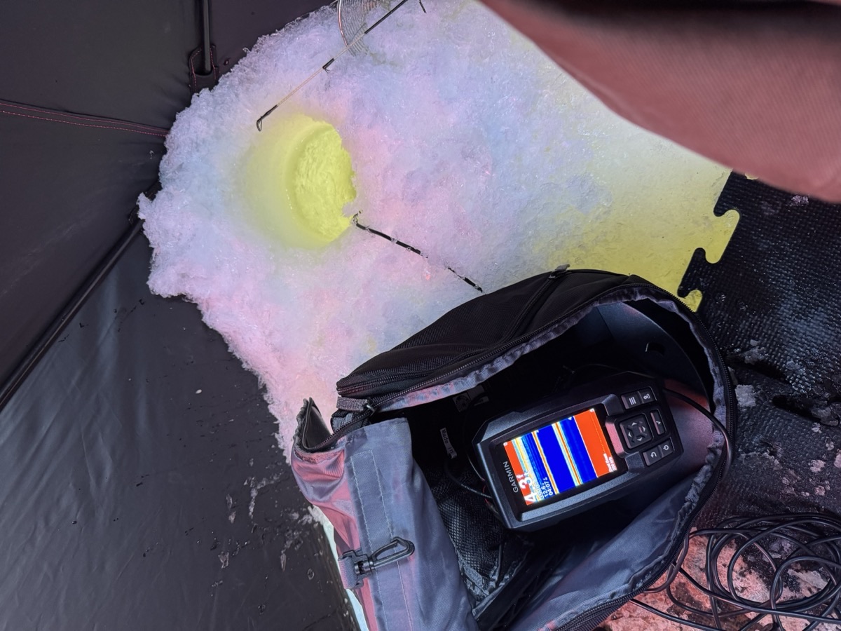 Garmin Striker fish finder showing 4.3 feet of depth next to the ice hole