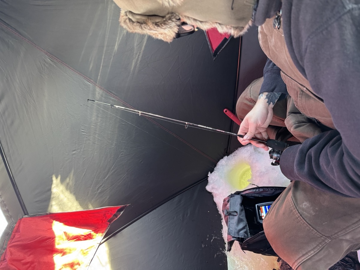 Jigging with a Shakespeare ice rod inside the shelter