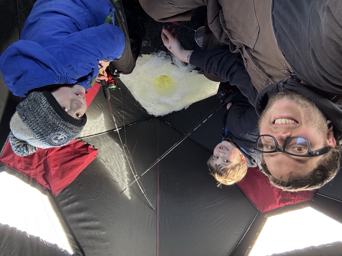 Joey with Julian and Emery inside the ice fishing shelter